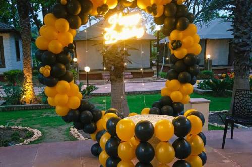 Outdoor Birthday Decoration with Black and Yellow Balloon Arch in Ghaziabad